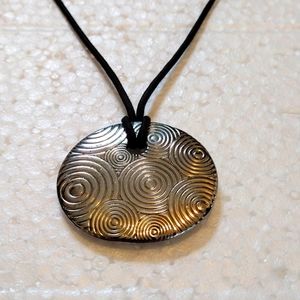 Lia Sofia medallion pendant on faux leather strand necklace.